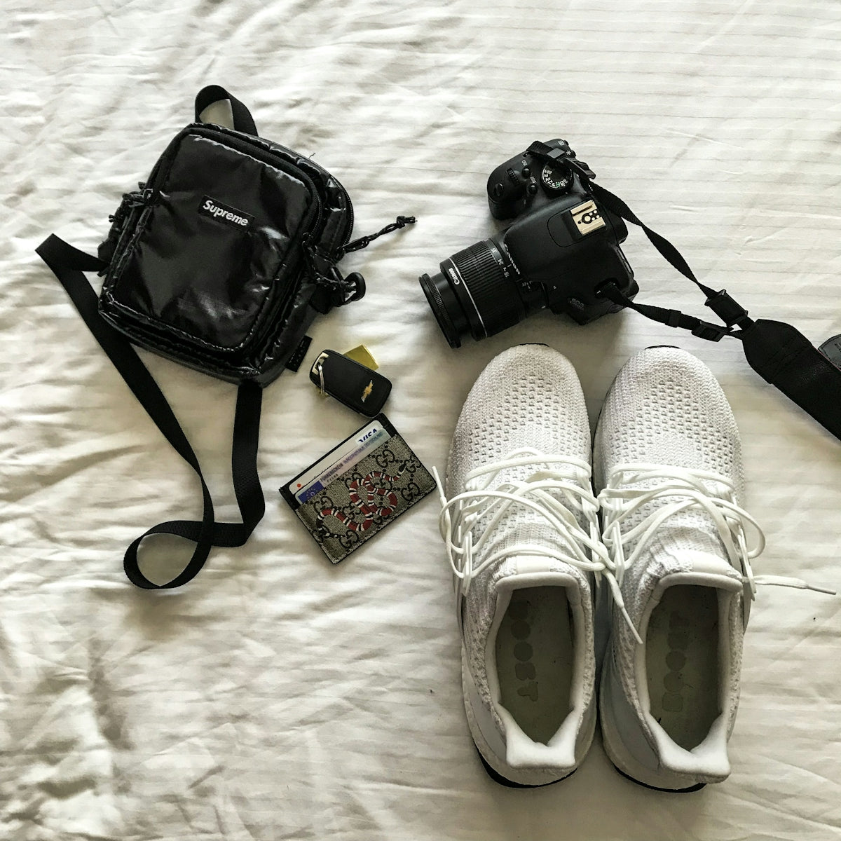 black dslr camera on white textile